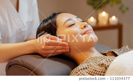 Woman receiving treatment at beauty salon, facial massage, oil massage Woman receiving treatment at beauty salon, facial massage, oil massage 111034377