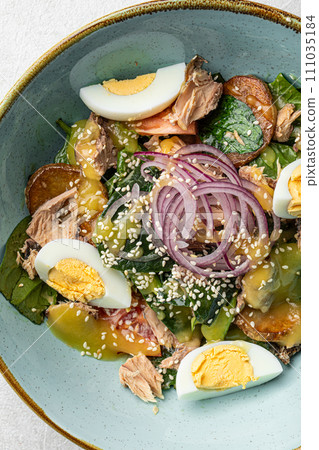 Portion of tuna salad with eggs and vegetables Portion of tuna salad with eggs and vegetables 111035184