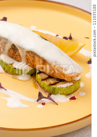 Portion of gourmet salmon steak on zucchini 111035188