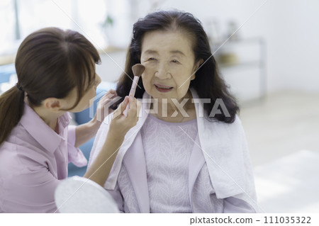 Senior woman receiving beauty treatment at home Senior woman receiving beauty treatment at home 111035322