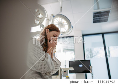 Close up of scared teenage patient, waitng for test results. Anxiety, worry and loneliness of teenager in hospital. Emotional support for ill young woman. 111035798