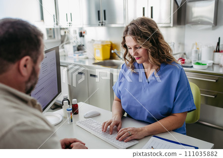 Doctor consulting with overweight patient, discussing test result and x-ray scans in doctor office. Concept of health risks of overwight and obesity. 111035882