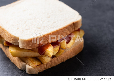 Sliced white bread on black slate background Sliced white bread on black slate background 111036846