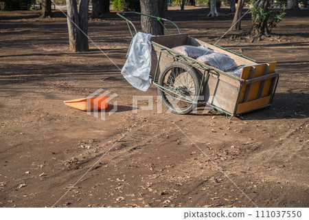 Sweeping the park: A cart loaded with fallen leaves Sweeping the park: A cart loaded with fallen leaves 111037550