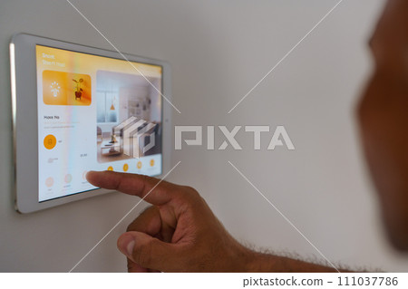 Man adjusting household functions, lighting, security cameras, door locks and thermostat or heating settings in smart home system. Man adjusting household functions, lighting, security cameras, door locks and thermostat or heating settings in smart home system. 111037786