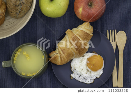 Breakfast soup, fried egg and croissant 111038238