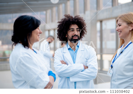 Group of doctors talking during conference. Medical networking. Medical experts attending an education event, seminar in board room. Age and gender equity in healthcare. 111038402