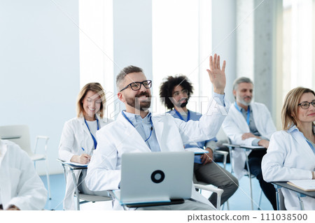 Medical team on conference, doctor asking question to speaker. Medical experts attending an education event, seminar in board room. 111038500