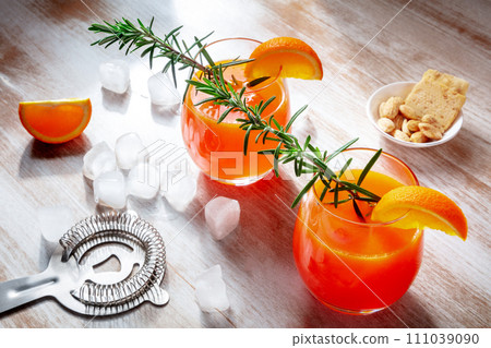 Orange drinks on a wooden background, fresh pressed juice with rosemary 111039090