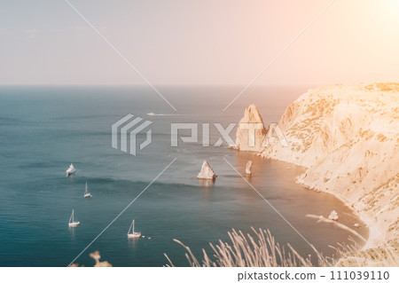 Aerial view from above on calm azure sea and volcanic rocky shores. Small waves on water surface in motion blur. Nature summer ocean sea beach background. Nobody. Holiday, vacation and travel concept Aerial view from above on calm azure sea and volcanic rocky shores. Small waves on water surface in motion blur. Nature summer ocean sea beach background. Nobody. Holiday, vacation and travel concept 111039110