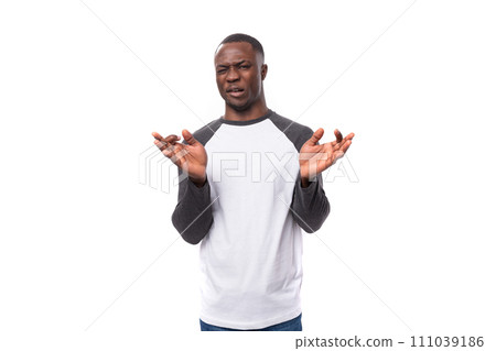 young handsome african guy with short haircut is having doubts young handsome african guy with short haircut is having doubts 111039186