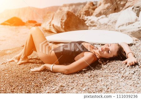 Woman sea sup. Close up portrait of happy young caucasian woman with long hair looking at camera and smiling. Cute woman portrait in bikini posing on sup board in the sea Woman sea sup. Close up portrait of happy young caucasian woman with long hair looking at camera and smiling. Cute woman portrait in bikini posing on sup board in the sea 111039236