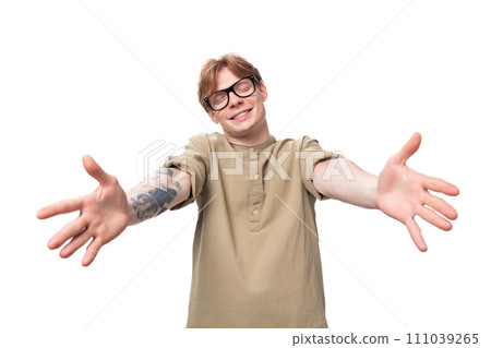 young charming caucasian guy with red hair in a khaki shirt stretches out his arms for a hug 111039265