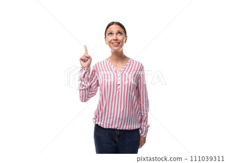 young european woman with black hair pulled back in a ponytail wearing a striped blouse and jeans on 111039311