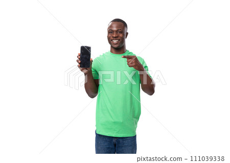 young surprised american man dressed in green t-shirt shows smartphone with mockup young surprised american man dressed in green t-shirt shows smartphone with mockup 111039338