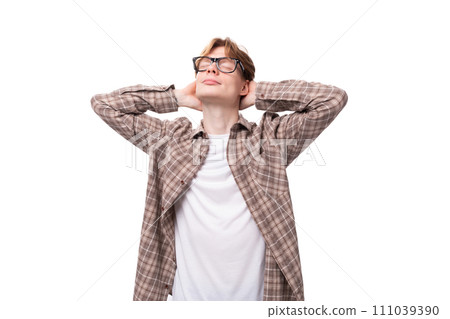 close-up portrait of a young dreaming caucasian man with red short hair in glasses and a shirt on a 111039390