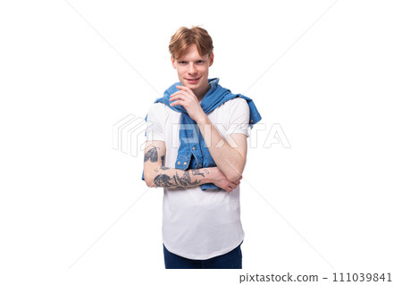 young successful red-haired guy in a blue shirt on a white background with copy space young successful red-haired guy in a blue shirt on a white background with copy space 111039841