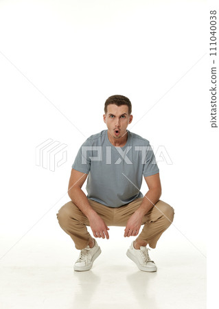 surprised guy looking at camera on white studio background 111040038