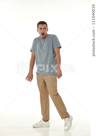 surprised guy looking at camera on white studio background 111040039