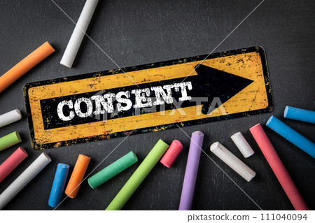Consent. Direction arrow with text on a dark chalkboard background Consent. Direction arrow with text on a dark chalkboard background 111040094
