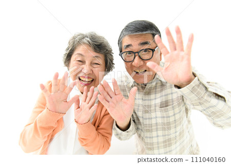 Senior couple playing peek-a-boo Senior couple playing peek-a-boo 111040160