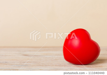 gift box with red bow and red heart on colored background. Perspective view. Flat lay 111040440