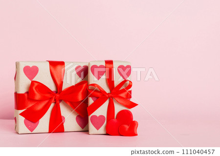 gift box with red bow and red heart on colored background. Perspective view. Flat lay 111040457