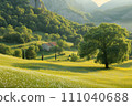 beautiful spring landscape in the mountains with a small house on the hill 111040688