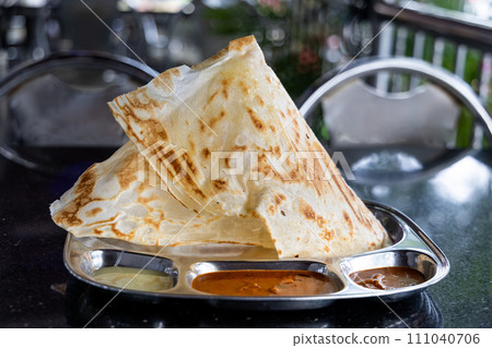 Roti Tisu or Tissue Bread is crunchy form of bread served at mamak restaurant in Malaysia Roti Tisu or Tissue Bread is crunchy form of bread served at mamak restaurant in Malaysia 111040706
