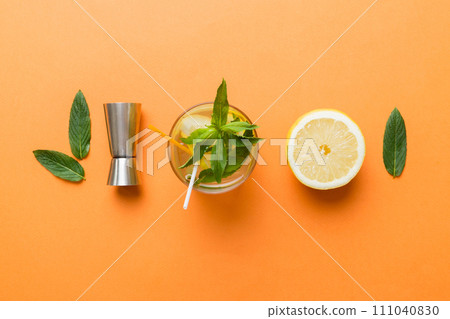 Caipirinha, Mojito cocktail, vodka or soda drink with lime, mint and straw on table background. Refreshing beverage with mint and lime in glass top view flat lay Caipirinha, Mojito cocktail, vodka or soda drink with lime, mint and straw on table background. Refreshing beverage with mint and lime in glass top view flat lay 111040830