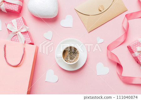 Mug coffee and gift box on colored background. Flat lay composition. Holiday concept Mug coffee and gift box on colored background. Flat lay composition. Holiday concept 111040874