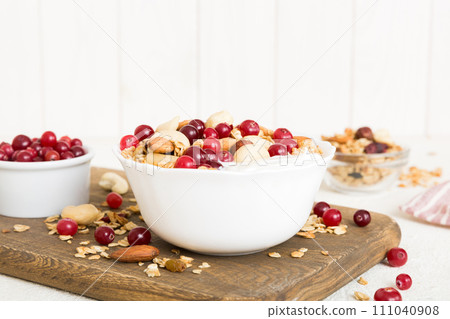 Healthy breakfast food with granola, yogurt, fruits and nuts. Dessert parfait with dried fruits for breakfast 111040908