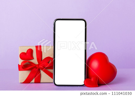 mobile phone with blank screen on colored background with hearts, calendar and gift box, valentine day concept perspertive view flat lay mobile phone with blank screen on colored background with hearts, calendar and gift box, valentine day concept perspertive view flat lay 111041030