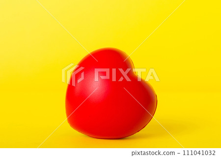 gift box with red bow and red heart on colored background. Perspective view. Flat lay 111041032