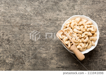 cashew nuts in wooden bowl on table background. top view. Space for text Healthy food 111041098