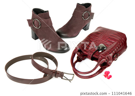Lady's handbag, ankle boots and leather belt isolated on a white . Collage. Lady's handbag, ankle boots and leather belt isolated on a white . Collage. 111041646