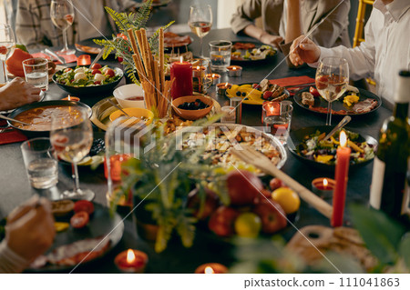 Cozy holiday table setting with different delicious food and beverages ready for friends home party 111041863