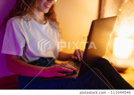 Young woman with laptop. Freelance or studying concept. Online training, shopping, blogging. Young woman with laptop. Freelance or studying concept. Online training, shopping, blogging. 111044046