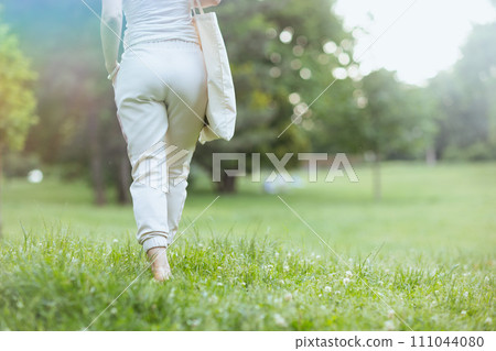 Closeup on female in white shirt walking 111044080