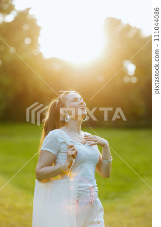 happy elegant 40 years old woman in white shirt enjoying happy elegant 40 years old woman in white shirt enjoying 111044086