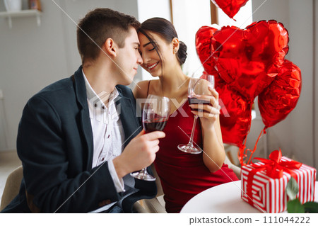 Valentine's Day concept. Romantic Date. Young couple celebrating Valentine's Day in the restaurant. Valentine's Day concept. Romantic Date. Young couple celebrating Valentine's Day in the restaurant. 111044222