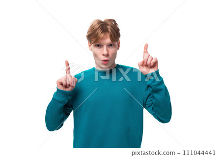 a young red-haired man with a blue sweater announces the news. advertising concept 111044441