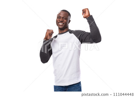 young cheerful african guy with short haircut dancing on white background 111044448