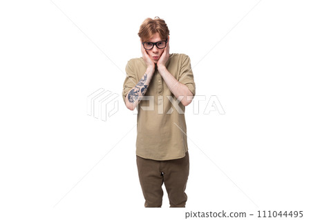 young shocked surprised redhead caucasian guy dressed in khaki short sleeve shirt young shocked surprised redhead caucasian guy dressed in khaki short sleeve shirt 111044495