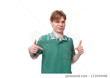 young charming adorable ginger man with a tattoo on his arm dressed in a green short sleeve t-shirt young charming adorable ginger man with a tattoo on his arm dressed in a green short sleeve t-shirt 111044496