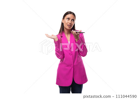 young well-groomed brunette successful boss woman dressed in a pink jacket speaks on the phone 111044590