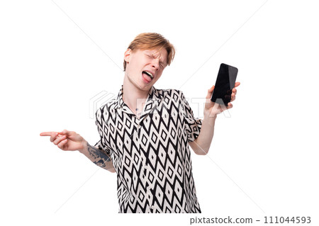 a young european man with golden hair dressed in a black and white shirt is dancing holding a a young european man with golden hair dressed in a black and white shirt is dancing holding a 111044593