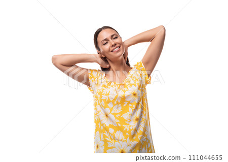 young pretty brunette woman dressed in a summer yellow t-shirt experiencing joy and satisfaction 111044655