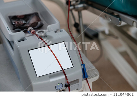 Blood bag placed on medical device during process on blood transfusion in hospital 111044801