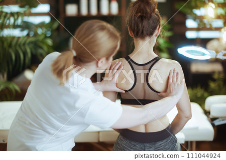 massage therapist checking clients back condition massage therapist checking clients back condition 111044924